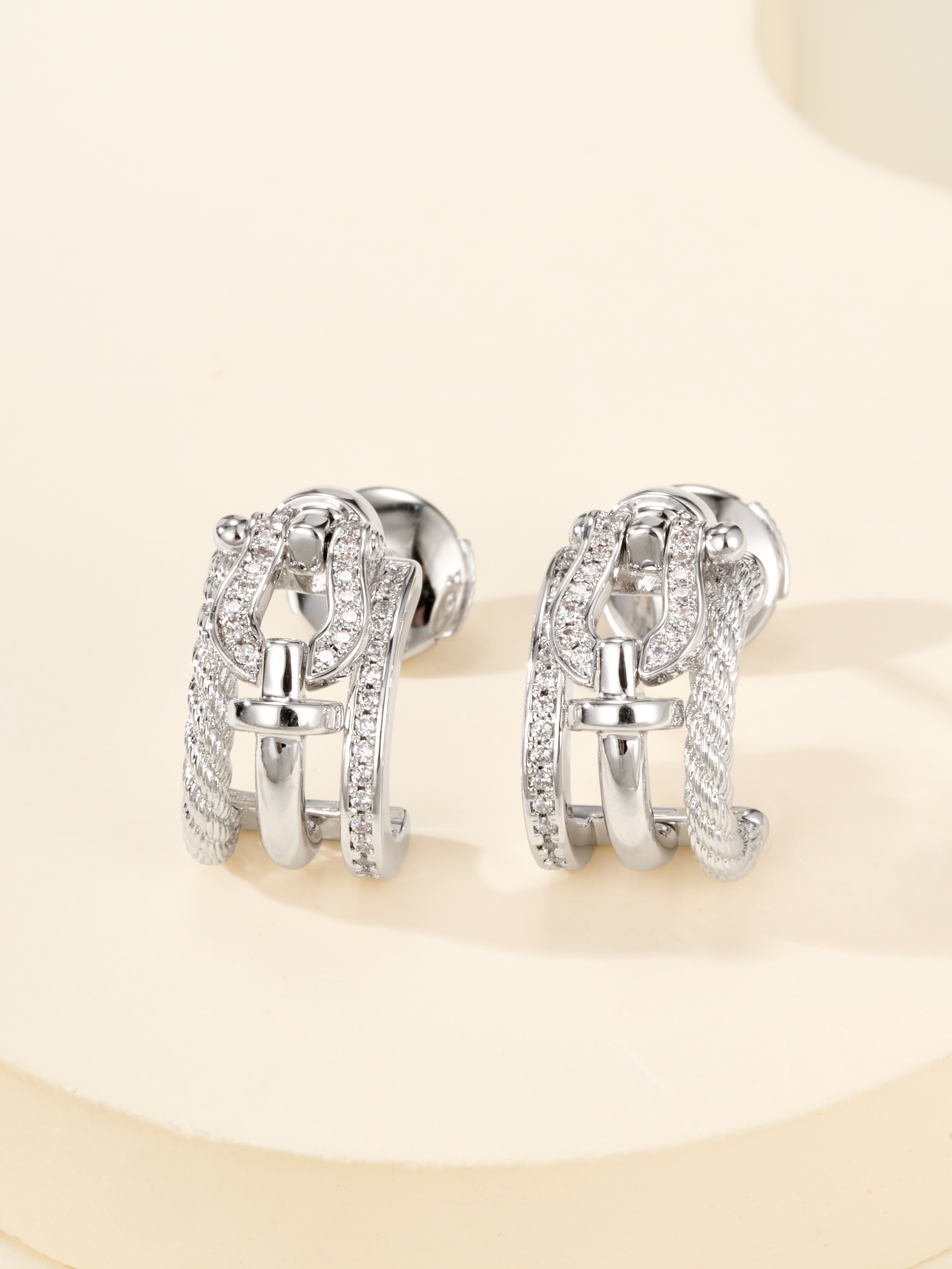 Half circle diamond studded earrings on horse hooves