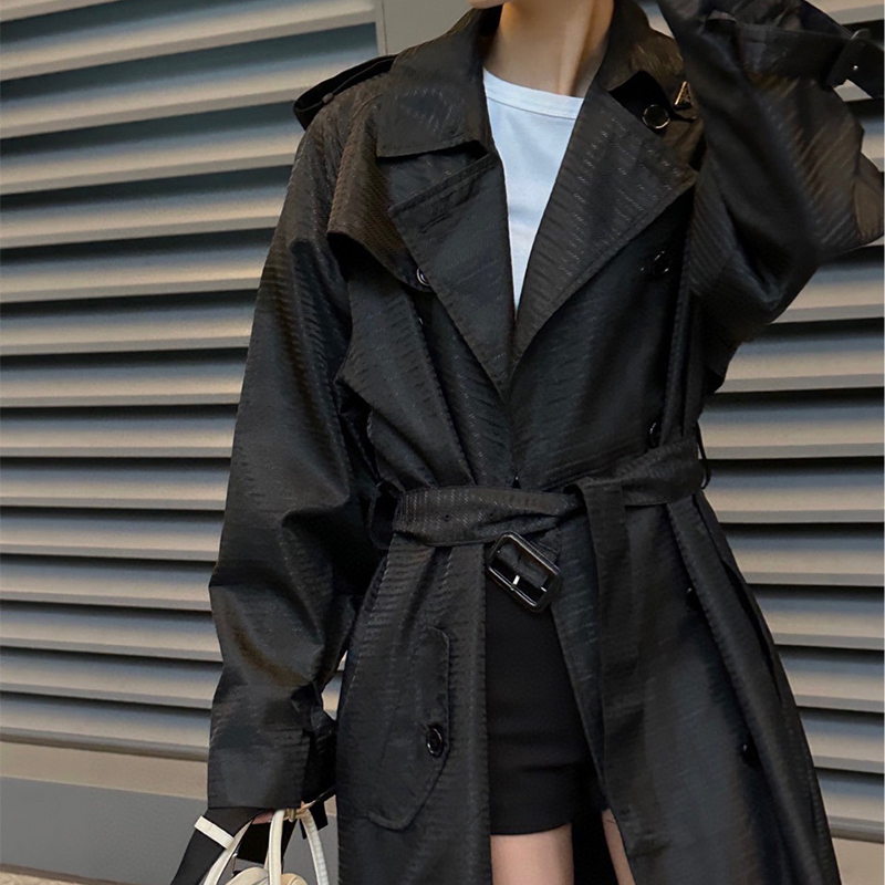 Black nylon jacquard trench coat with a long flip collar and double row buckle tie